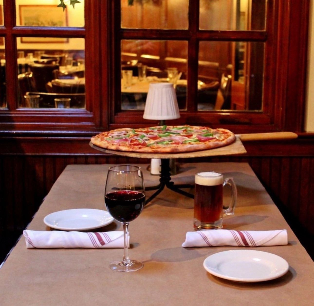 A table set for dinner with pizza and wine at Roadhouse