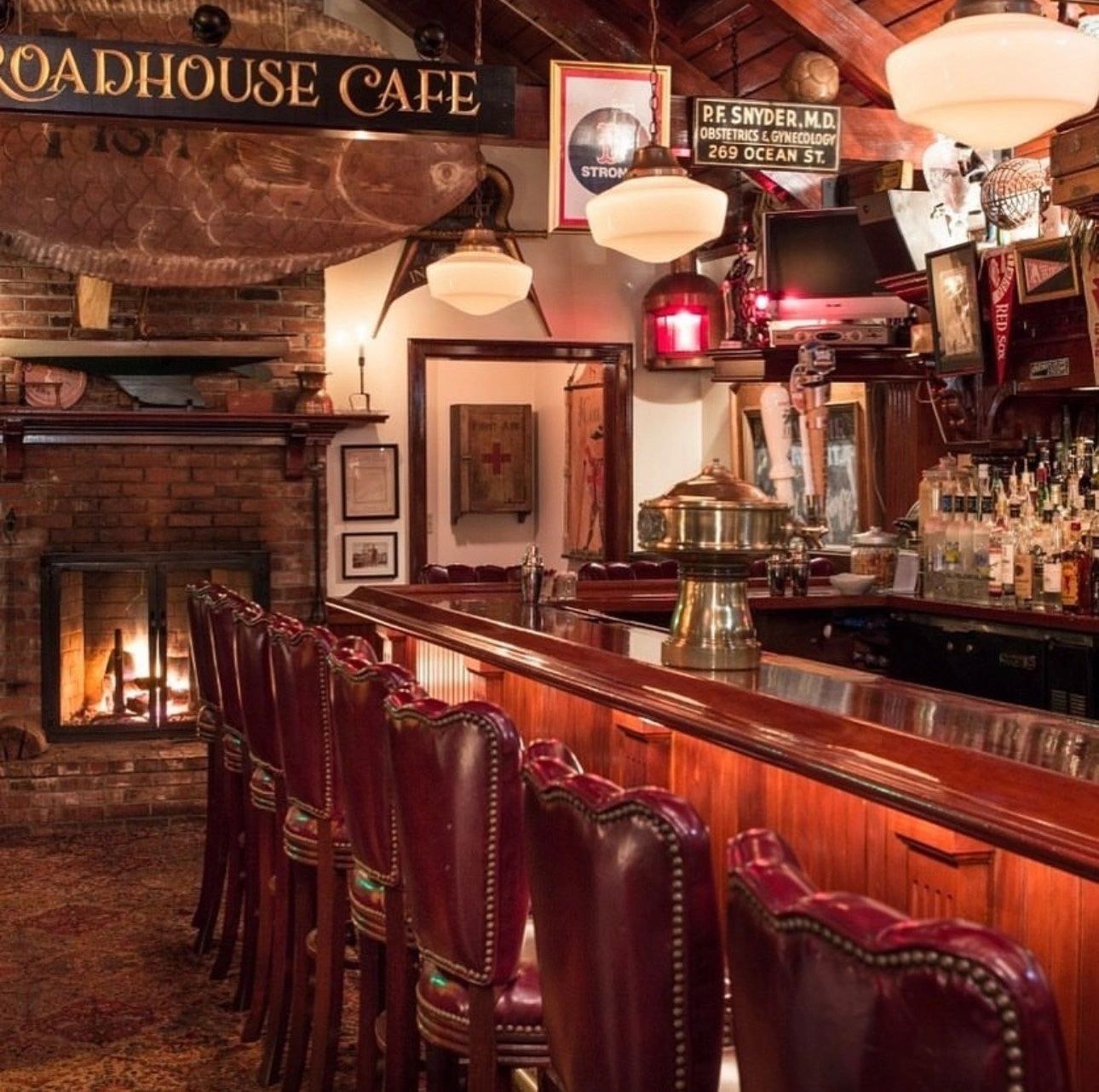 Warm wood bar and fireplace inside Roadhouse Cafe in Hyannis